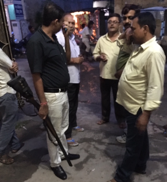 Outside Mishra Nursing Home, the doctor's aide wields a gun. (Photo credit: Menaka Rao). Outside Mishra Nursing Home, the doctor's aide wields a gun. (Photo credit: Menaka Rao).