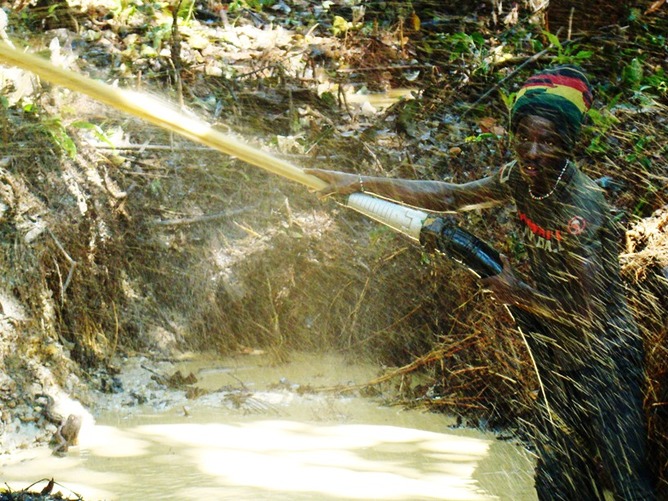An illegal gold miner scours the forest soils in Suriname, South America. William Laurance An illegal gold miner scours the forest soils in Suriname, South America. William Laurance