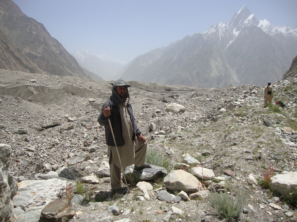 Member of monitoring team standing in front of a Debris-covered Glacier. Courtesy: Water and Power Development Authority Member of monitoring team standing in front of a Debris-covered Glacier. Courtesy: Water and Power Development Authority