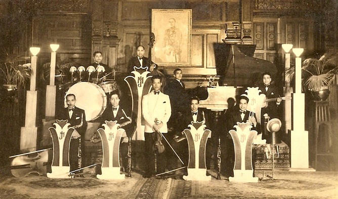 A young Joe Menezes (centre, white jacket) with his band. Courtesy Terence Menezes. A young Joe Menezes (centre, white jacket) with his band. Courtesy Terence Menezes.