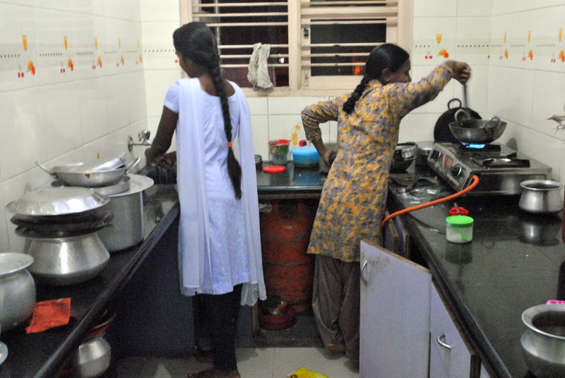 After a long day at work, young garment workers from Odisha cook dinner in their hostel in Bengaluru. Photo credit: Rohini Mohan. After a long day at work, young garment workers from Odisha cook dinner in their hostel in Bengaluru. Photo credit: Rohini Mohan.