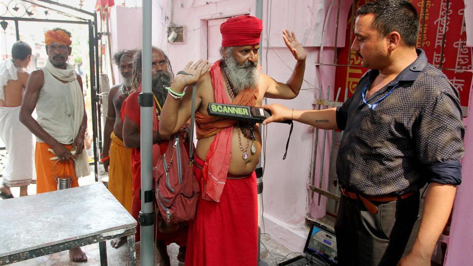 Sadhus undergo a security check before registering for the Amarnath Yatra in Jammu. (Photo credit: PTI). Sadhus undergo a security check before registering for the Amarnath Yatra in Jammu. (Photo credit: PTI).