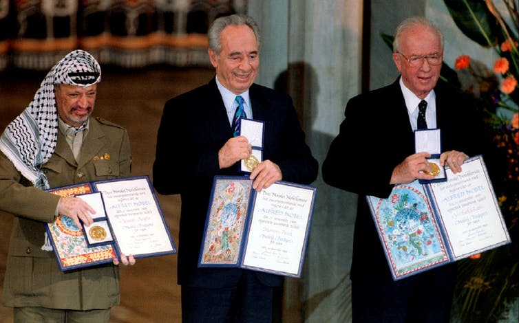 Yasser Arafat, Shimon Peres and Yitzhak Rabin show their shared Nobel Peace Prize. Photo credit: Jerry Lampen/Reuters Yasser Arafat, Shimon Peres and Yitzhak Rabin show their shared Nobel Peace Prize. Photo credit: Jerry Lampen/Reuters