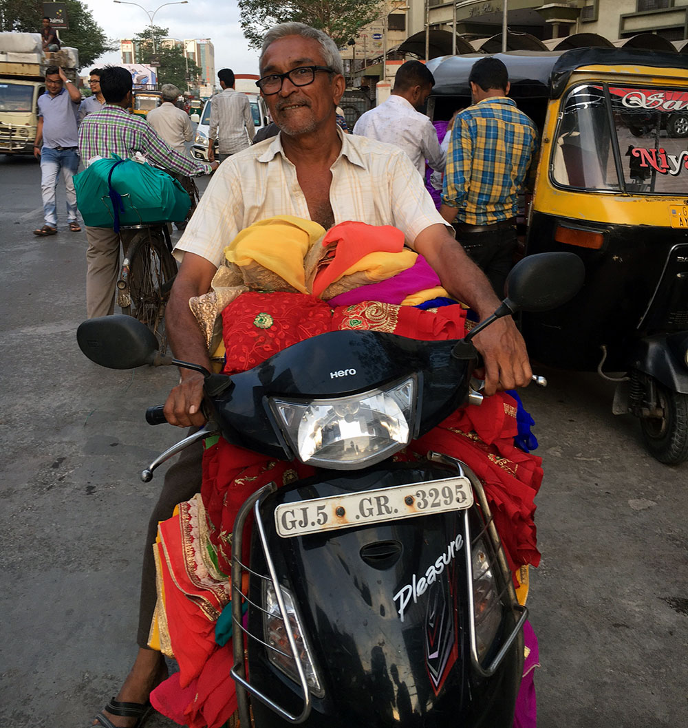 A small shopkeeper prepares to scooter back home with the stock he has just bought. Photo credit: M Rajshekhar A small shopkeeper prepares to scooter back home with the stock he has just bought. Photo credit: M Rajshekhar