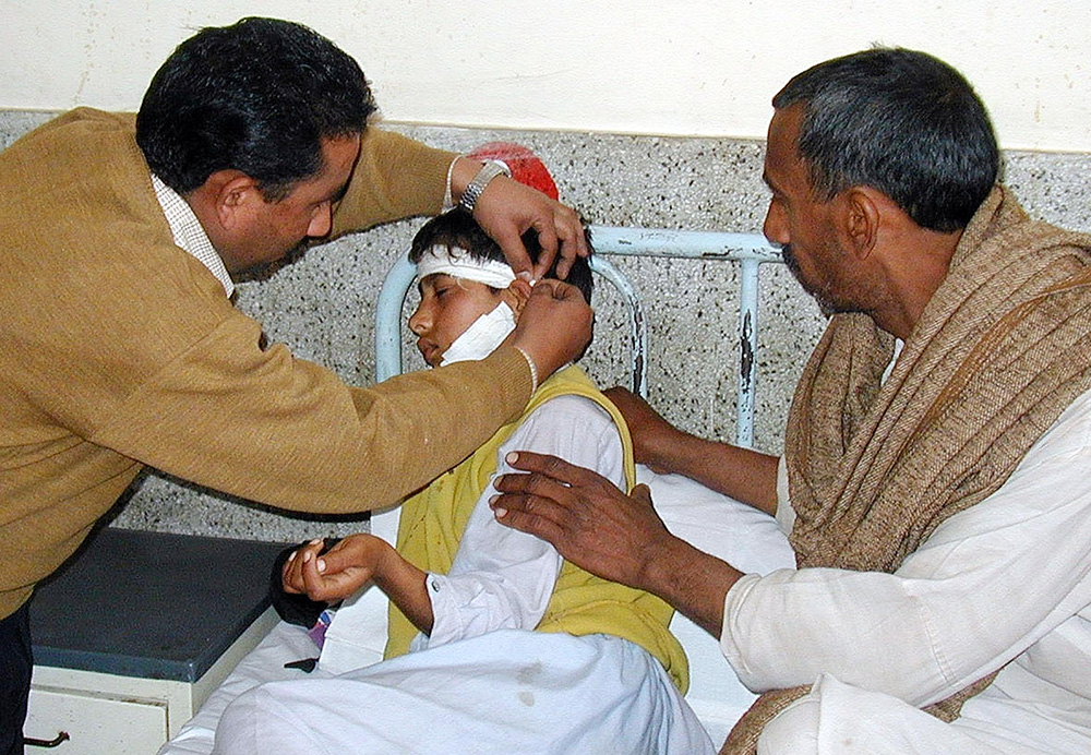 A paramedic treats Muhammad Raqeeb, who was wounded by Indian shelling in Nakyal sector, 250 kms south of Muzaffarabad, capital city of Pakistan-administered Kashmir, in February 2003. Credit: AFP A paramedic treats Muhammad Raqeeb, who was wounded by Indian shelling in Nakyal sector, 250 kms south of Muzaffarabad, capital city of Pakistan-administered Kashmir, in February 2003. Credit: AFP