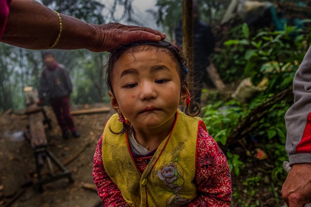 A child plays while her family builds their hut. Professional sherpas continue risking their lives so that their children can get good education. A child plays while her family builds their hut. Professional sherpas continue risking their lives so that their children can get good education.