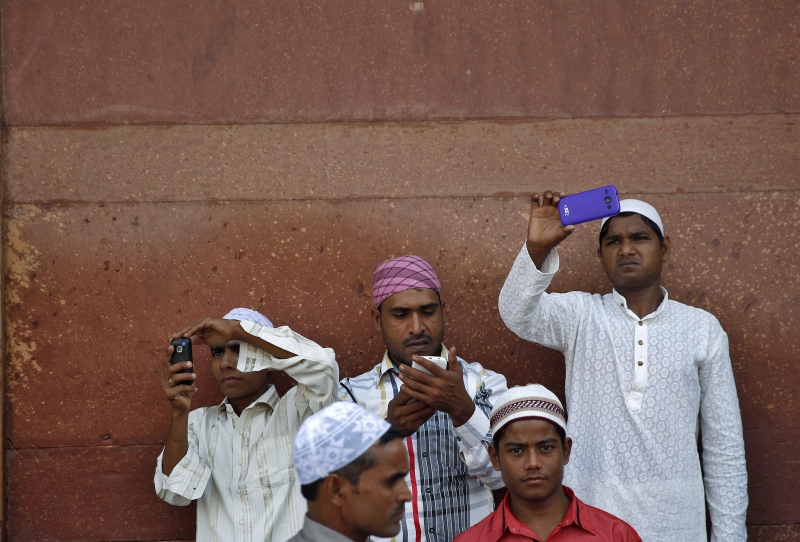 Muslims use their mobile phones after offering Eid prayers at the Jama Masjid in Old Delhi in 2014. (Photo credit: Reuters). Muslims use their mobile phones after offering Eid prayers at the Jama Masjid in Old Delhi in 2014. (Photo credit: Reuters).