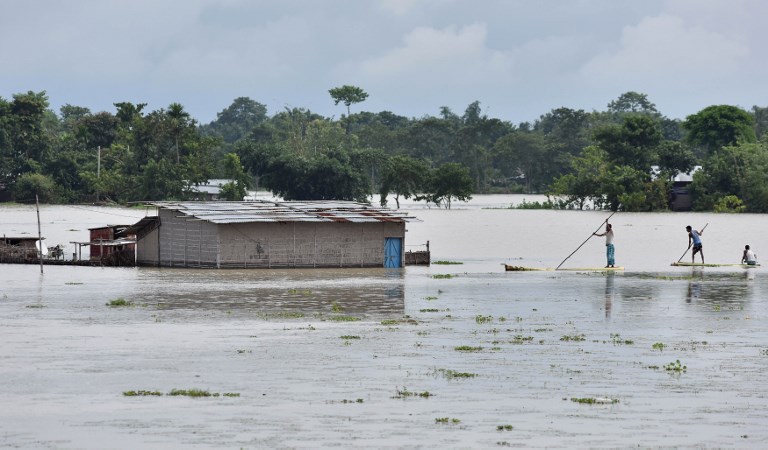 Villagers paddle their rafts near a partially submerged house in Tezpur, 170 km from Guwahati. (Credit: Biju Boro/AFP) Villagers paddle their rafts near a partially submerged house in Tezpur, 170 km from Guwahati. (Credit: Biju Boro/AFP)