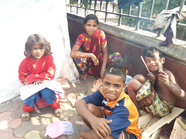 Archana Shaikh with other children from her family on the pavement where they live. Archana Shaikh with other children from her family on the pavement where they live.