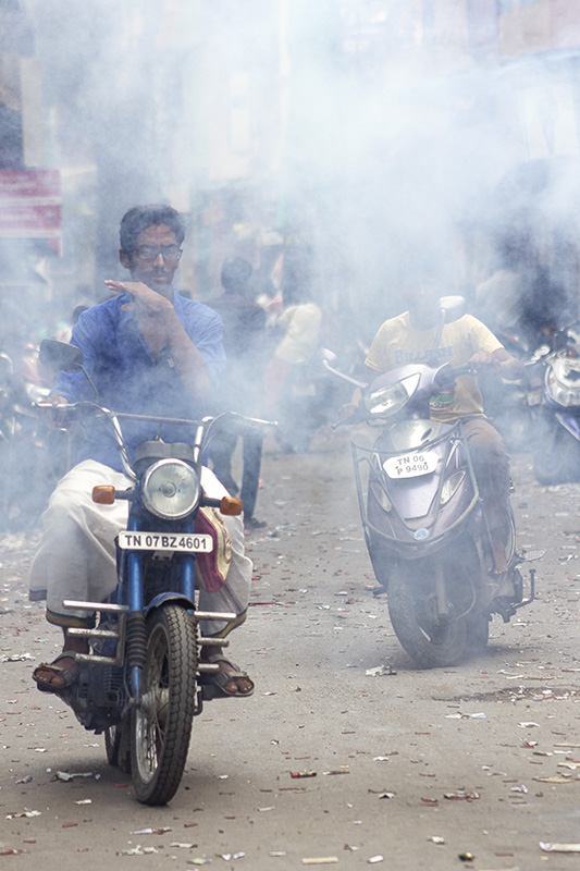 Despite constant eye burns and difficulty in driving because of the ash and small residue particles from the crackers, these riders did not take to helmets and masks on Diwali. Mylapore, Chennai, 18 Oct, 2017. Photo credit: Shuchi Kapoor/Chennai Despite constant eye burns and difficulty in driving because of the ash and small residue particles from the crackers, these riders did not take to helmets and masks on Diwali. Mylapore, Chennai, 18 Oct, 2017. Photo credit: Shuchi Kapoor/Chennai