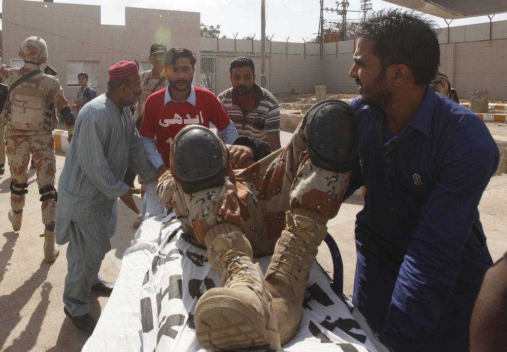 Safdar (centre, in red) wheels an injured paramilitary soldier to the ambulance. (Photo: Akthar Soomro/Reuters) Safdar (centre, in red) wheels an injured paramilitary soldier to the ambulance. (Photo: Akthar Soomro/Reuters)