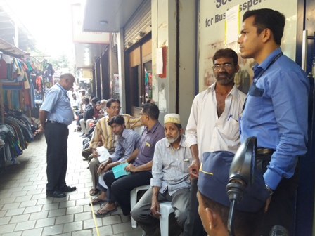 Citizens seated in line outside a bank at Crawford Market, Mumbai. Citizens seated in line outside a bank at Crawford Market, Mumbai.