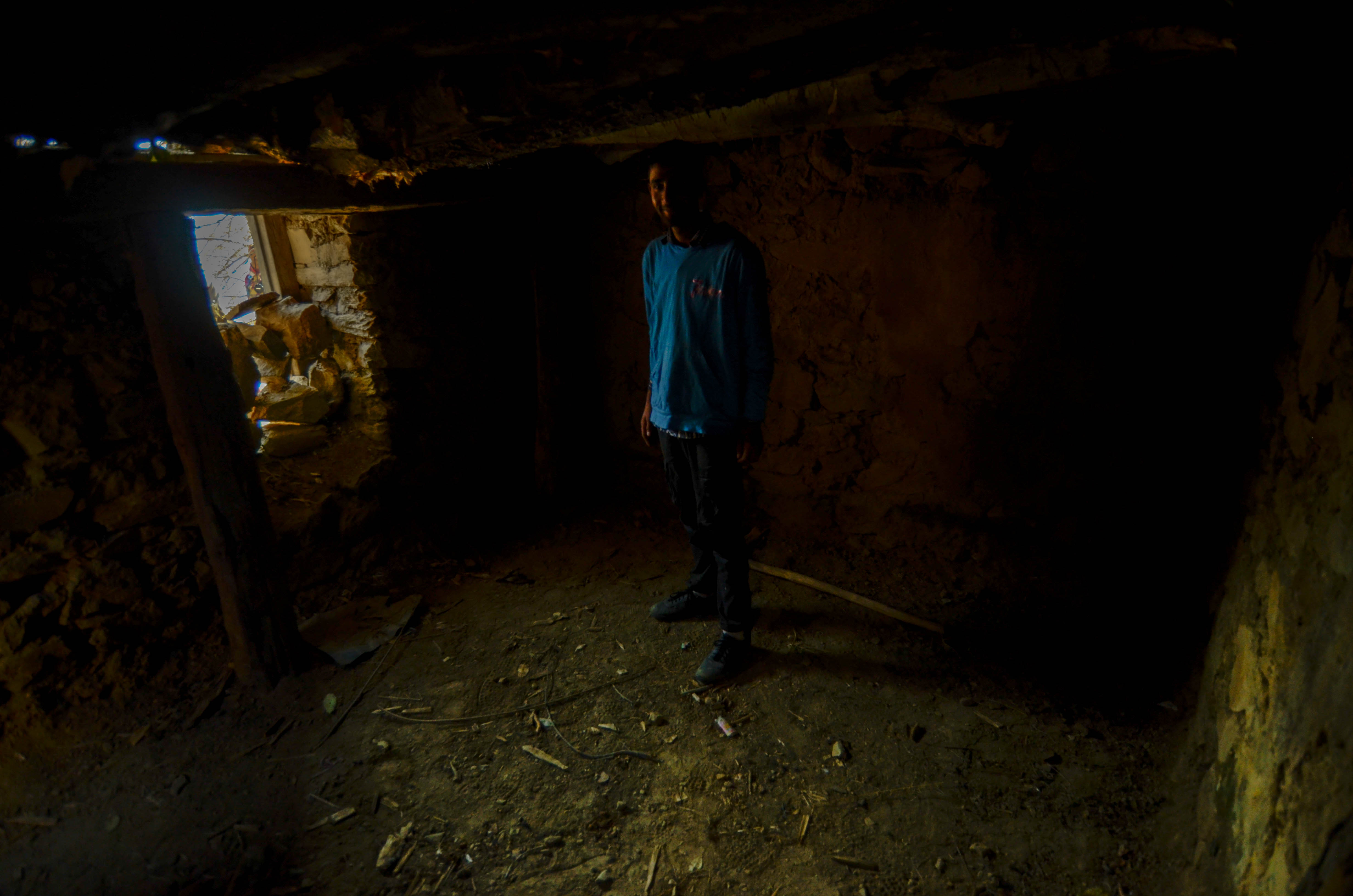 Shahzad Khan, a resident of Mandiya village, stands inside a make-shift bunker. Shahzad Khan, a resident of Mandiya village, stands inside a make-shift bunker.