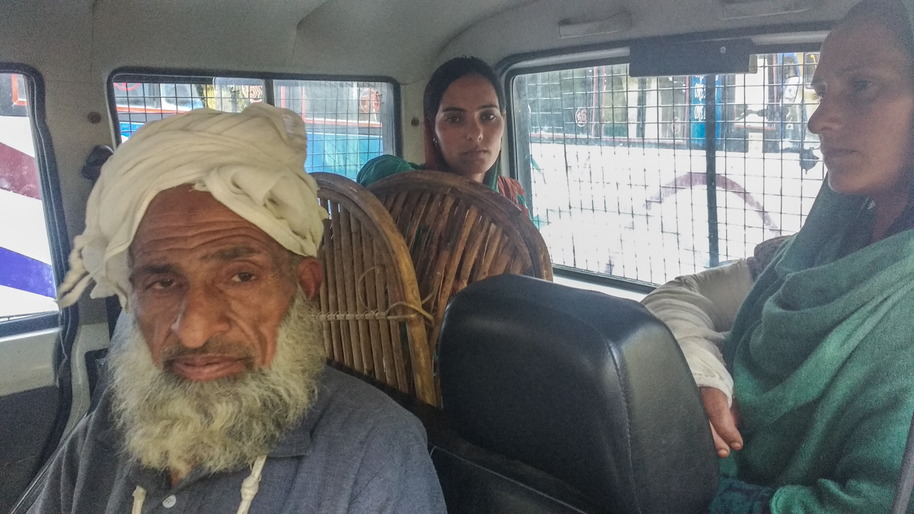 Sabir Ali (front), Abida Bibi (left), and Naseem Begum were escorted to their home in a police vehicle on Monday. Sabir Ali (front), Abida Bibi (left), and Naseem Begum were escorted to their home in a police vehicle on Monday.