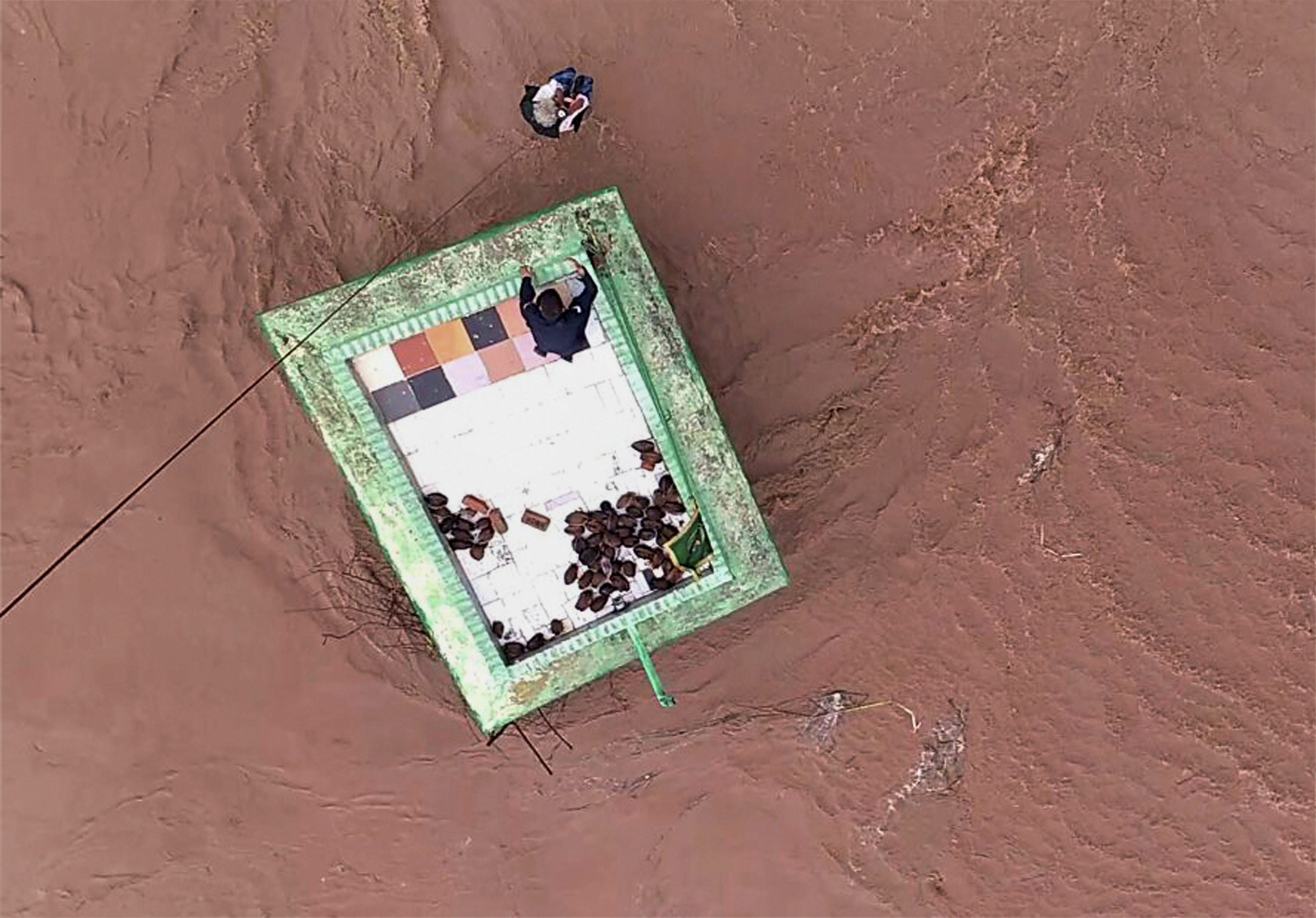 A person trapped on the terrace of a building surrounded by floodwater is rescued by the Indian Air Force in Utadi village in Gujarat's Surendranagar district in July 2017. (Photo credit: PTI). A person trapped on the terrace of a building surrounded by floodwater is rescued by the Indian Air Force in Utadi village in Gujarat's Surendranagar district in July 2017. (Photo credit: PTI).