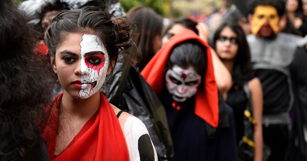 Enthusiastic Halloween revelers sporting eerie face paint designs for a spooky celebration