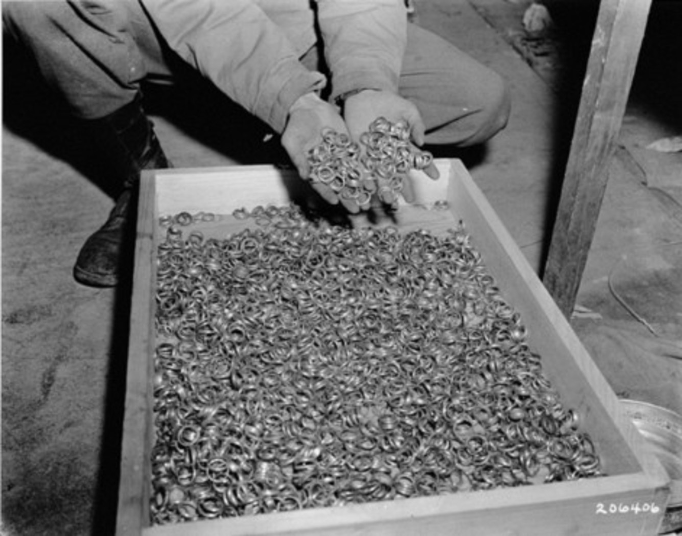 In this May 1945 image, a U.S. soldier dips his hands into a crate full of rings confiscated from prisoners in Buchenwald. National Archives and Records Administration In this May 1945 image, a U.S. soldier dips his hands into a crate full of rings confiscated from prisoners in Buchenwald. National Archives and Records Administration