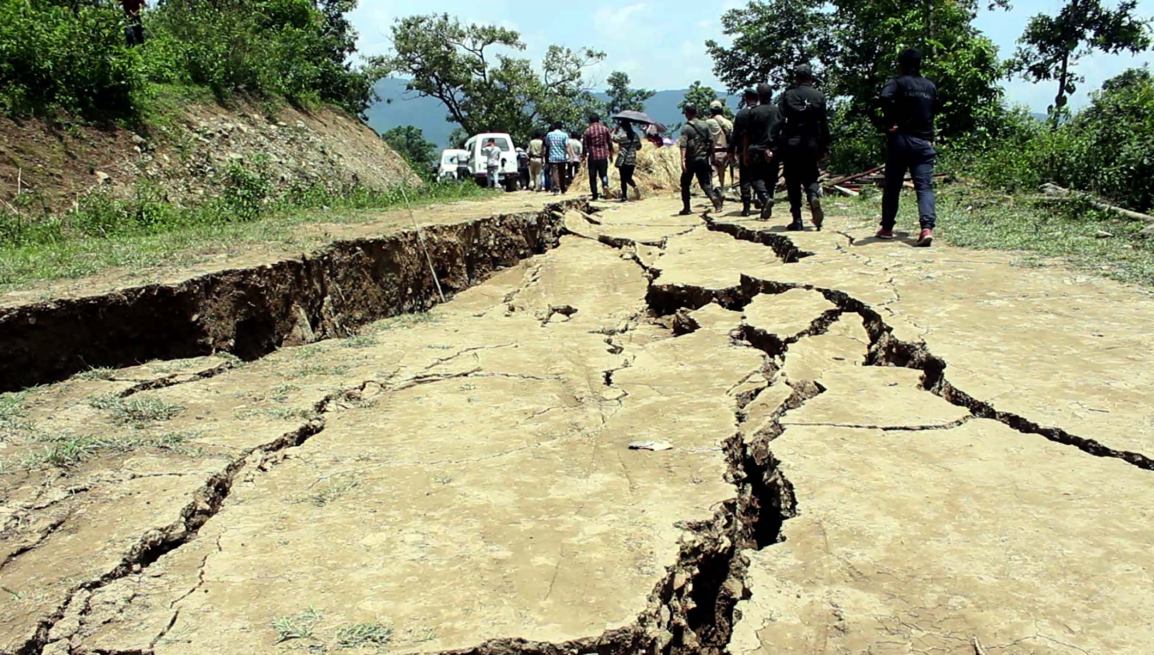 Earth cracks spread to the recently constructed Pradhan Mantri Gram Sadak Yojana Road.